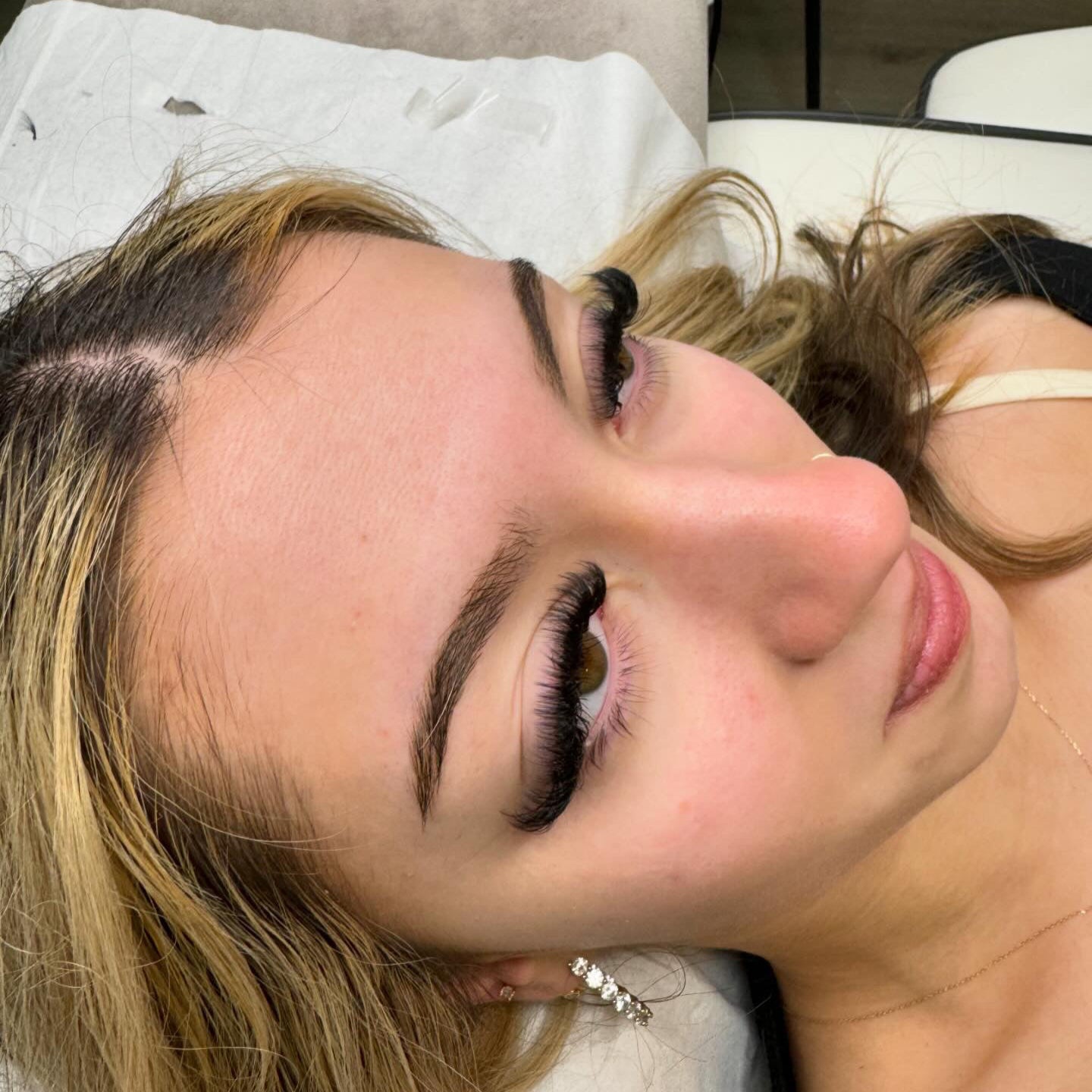 Trainer guiding lash artist through volume application and retention tips