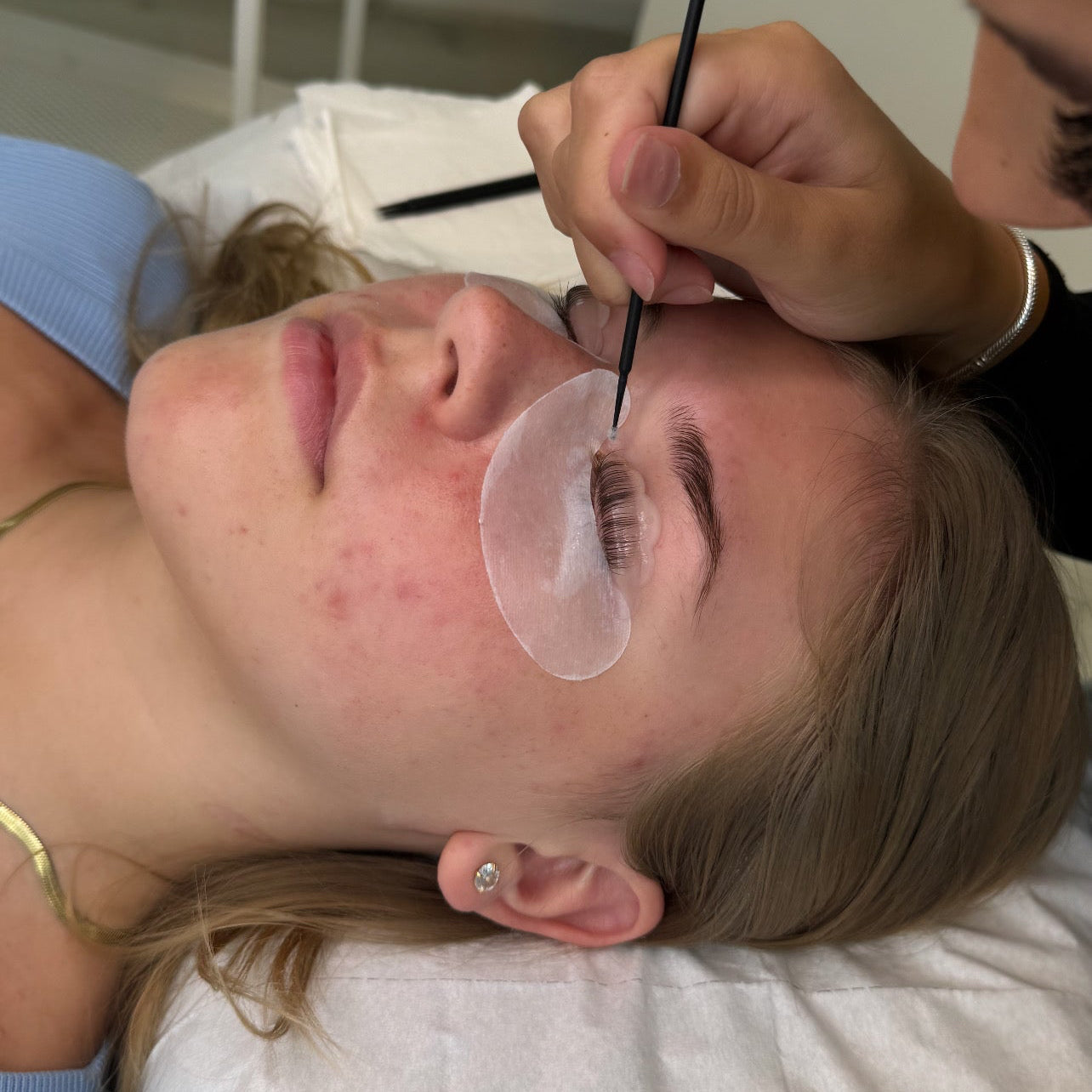 Student performing lash lift and tint on live model during training course in Reading