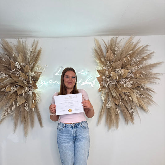 Certified lash technician holding classic lash course certificate